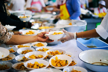 Homeless people are helped with food relief, famine relief : a social concept of sharing.