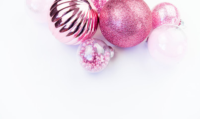 Gentle pink baubles on a white background. Christmas mood. Copy space