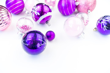 Gentle pink and purple baubles on a white background. Christmas mood.