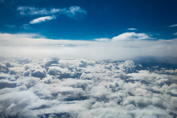 Fototapeta premium Aerial view White clouds in blue sky. Top view. View from the plane. Aerial bird's eye view.