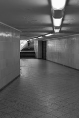 A person goes down the stairs into the underground