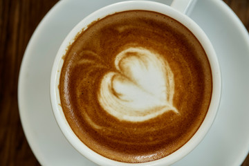 Cup of coffee with heart pattern