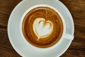 Cup of coffee with heart pattern