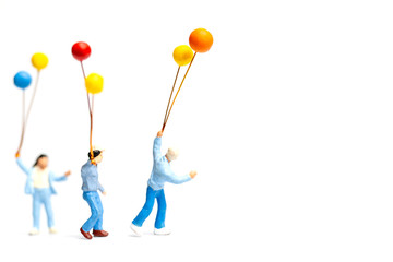 Miniature people : Children holding balloon on white background.