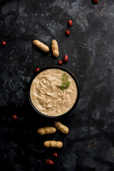 Healthy Peanut chutney made using Groundnut / Shengdana or mungfali. served in a small bowl with raw whole. Selective focus
