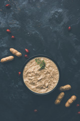 Healthy Peanut chutney made using Groundnut / Shengdana or mungfali. served in a small bowl with raw whole. Selective focus