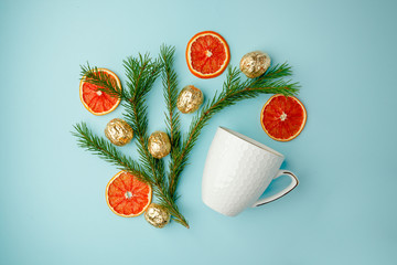 White cup of hot tea with candied orange and xmas decorative things Christmas winter beverage...
