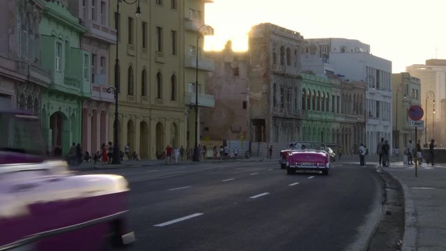 Colorful Classic 1950's American Vintage Cuban Convertible Taxi Cars driving on malecon street old Havana, Cuba