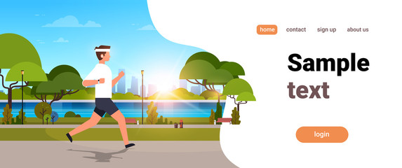 young man jogging outdoors modern public park guy in headphones running sport activity concept cityscape sunset background horizontal banner copy space