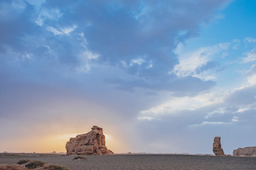 Huge yardang rock in gobi desert against sunset in Dunhuang Yardang National Geopark, Gansu, China