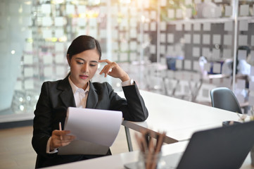 Business lady pondering over ideas for thinking new business project.