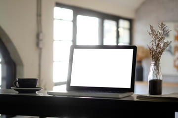 Fototapeta na wymiar Mockup laptop computer on blur cafe background.