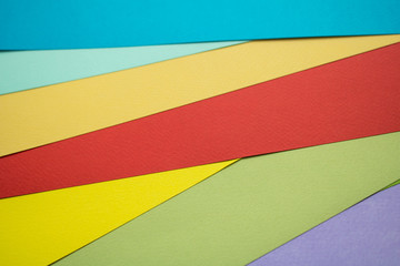 sheets of multicolored paper folded rainbow
