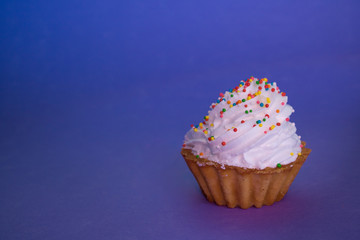 dessert with cream in a basket stands on a lilac background