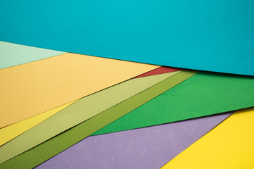 many colorful sheets of paper lie one on another