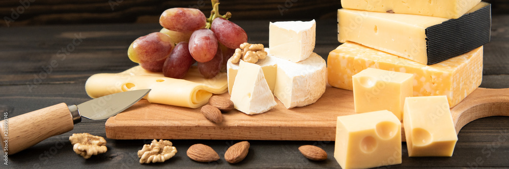 Wall mural various types of cheese on a rustic table