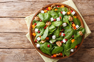 Delicious dietary salad of pumpkin, baby spinach, feta cheese, walnuts and pomegranate seeds...