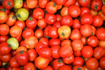 red tomato vines texture background - pile of ripe tomato vines sale in the market