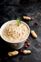 Healthy Peanut chutney made using Groundnut / Shengdana or mungfali. served in a small bowl with raw whole. Selective focus