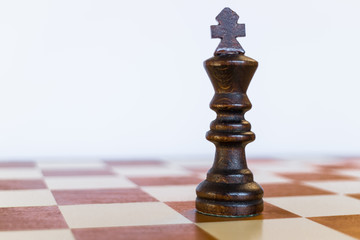 Black king on black square on chessboard