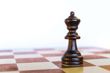 Black queen on black square on chessboard