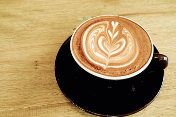 Hot coffee latte on a wooden table.