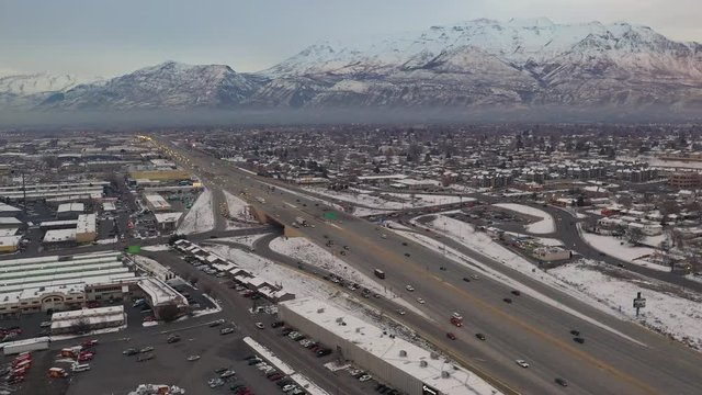 Aerial view of freeway intersection on I-15 in Utah County at Center Street in winter viewing the inversion.