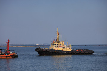 Tugboat sailing to the pier