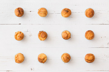 Homemade vanilla muffins on white retro wooden table or background. Healthy food, snack. Top view