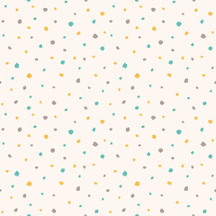 Uneven specks, spots, blobs, splashes seamless pattern. Easter background. Free hand drawn yellow, blue, brown speckles, flecks, stains or dots of different size texture. Abstract retro background.