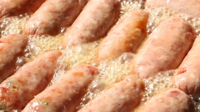 Frying Thai northeastern sausage in pan
