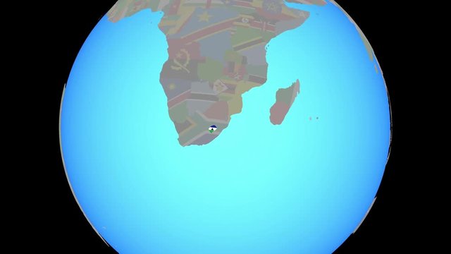 Closing in on Lesotho with national flag on blue political globe. 3D illustration.