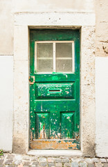 Fototapeta na wymiar Entrance door in the old house of the historic quarter in Lisbon, Portugal.