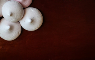 delicate airy meringue on brown background.