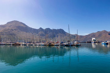 Hout Bay boats and mountain reflections morning view