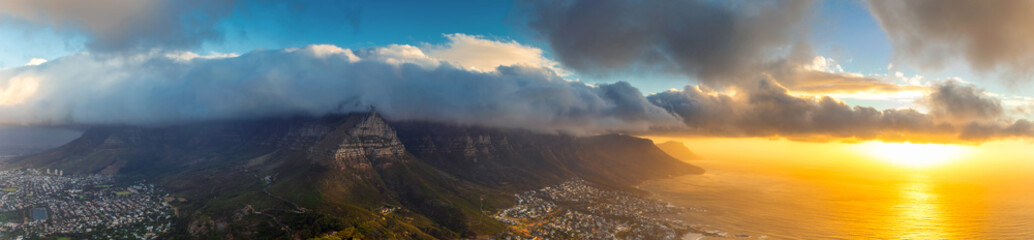 Lion's head top panoramic view of Table Mountain and Cape Town city at sunset with beatiful clouds in the sky