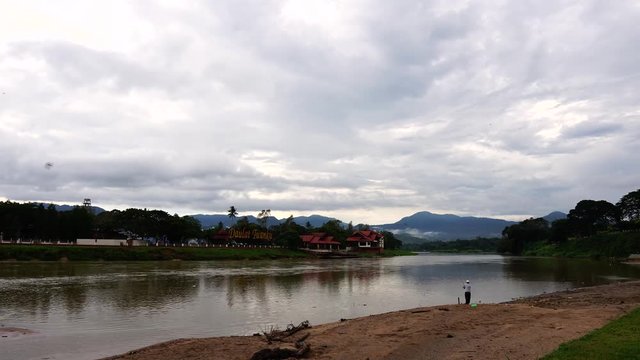 Timelapse of scenery at Sungai Perak with a view of DAULAT TUANKU sign meaning to affirm the sacred power of the king of the day in Kuala Kangsar Perak Malaysia. View of man fishing at  riverside.OUT