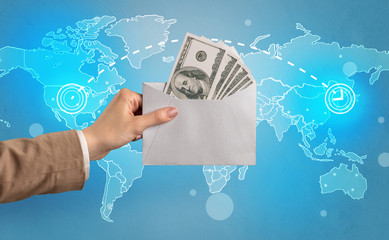 Female hand holding coloured and white envelope with blue map on the background
