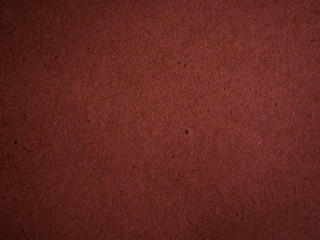Fototapeta premium Texture of dark red cardboard closeup, abstract paper background