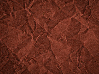Texture of dark red crumpled craft paper. Texture for design, abstract background