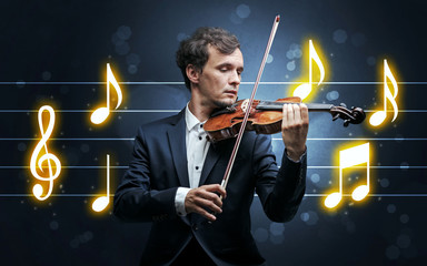 Young handsome fiddler playing with music sheet background