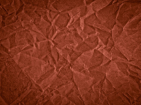 Texture of dark red crumpled craft paper. Texture for design, abstract background