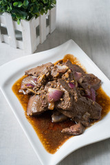 sautéed pork liver steak in ginger and fresh chopped onions