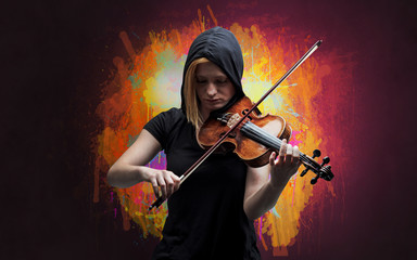 Young classical violinist musician with colorful splotch wallpaper
