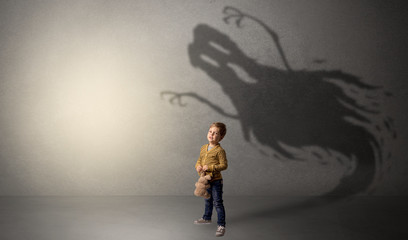 Scary ghost shadow in a dark empty room with a cute blond child
