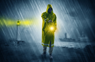 Man at the coast coming in raincoat with glowing lantern concept
