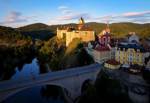 Panoramic view on Loket Castle (Hrad Loket, Burg Elbogen),  gothic style castle on a massive rock against blue sky, surrounded on three sides by the Ohře river near to Karlovy vary, Czech Republic.