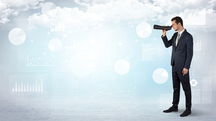 Businessman looking forward with binoculars cloudy background and graphs, charts around
