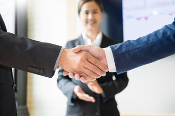 Close up of a business handshake, finishing up a meeting acquisition Greeting Deal concept.