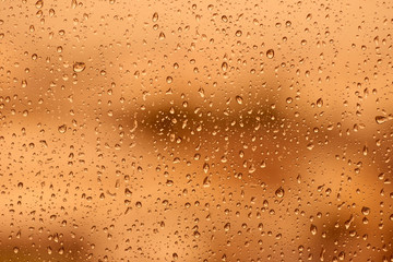 Gold tone for drops of water or rain drops on window glass